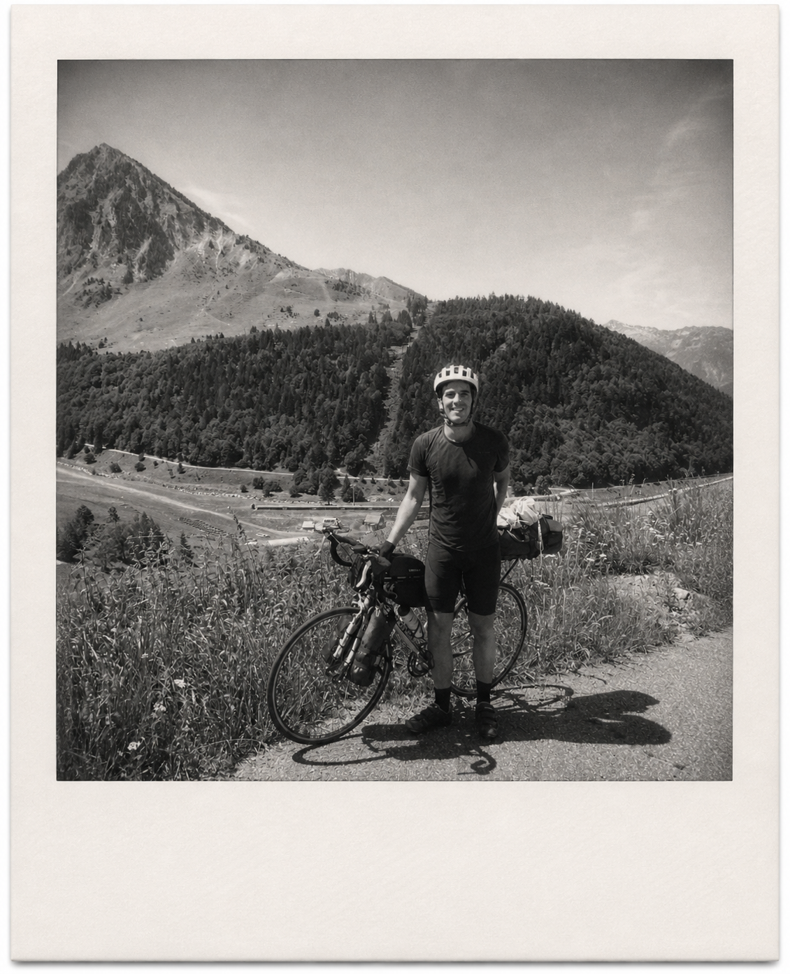 Álvaro with a bicycle on a mountain road
