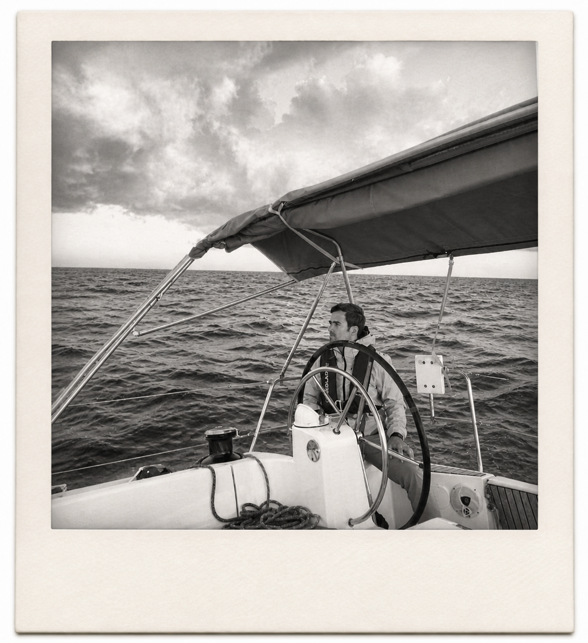 Álvaro at the helm of a sailboat at sea